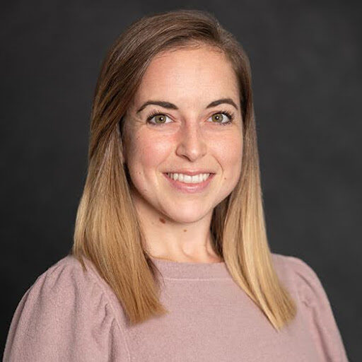 Headshot of a white woman with light brown straight hair